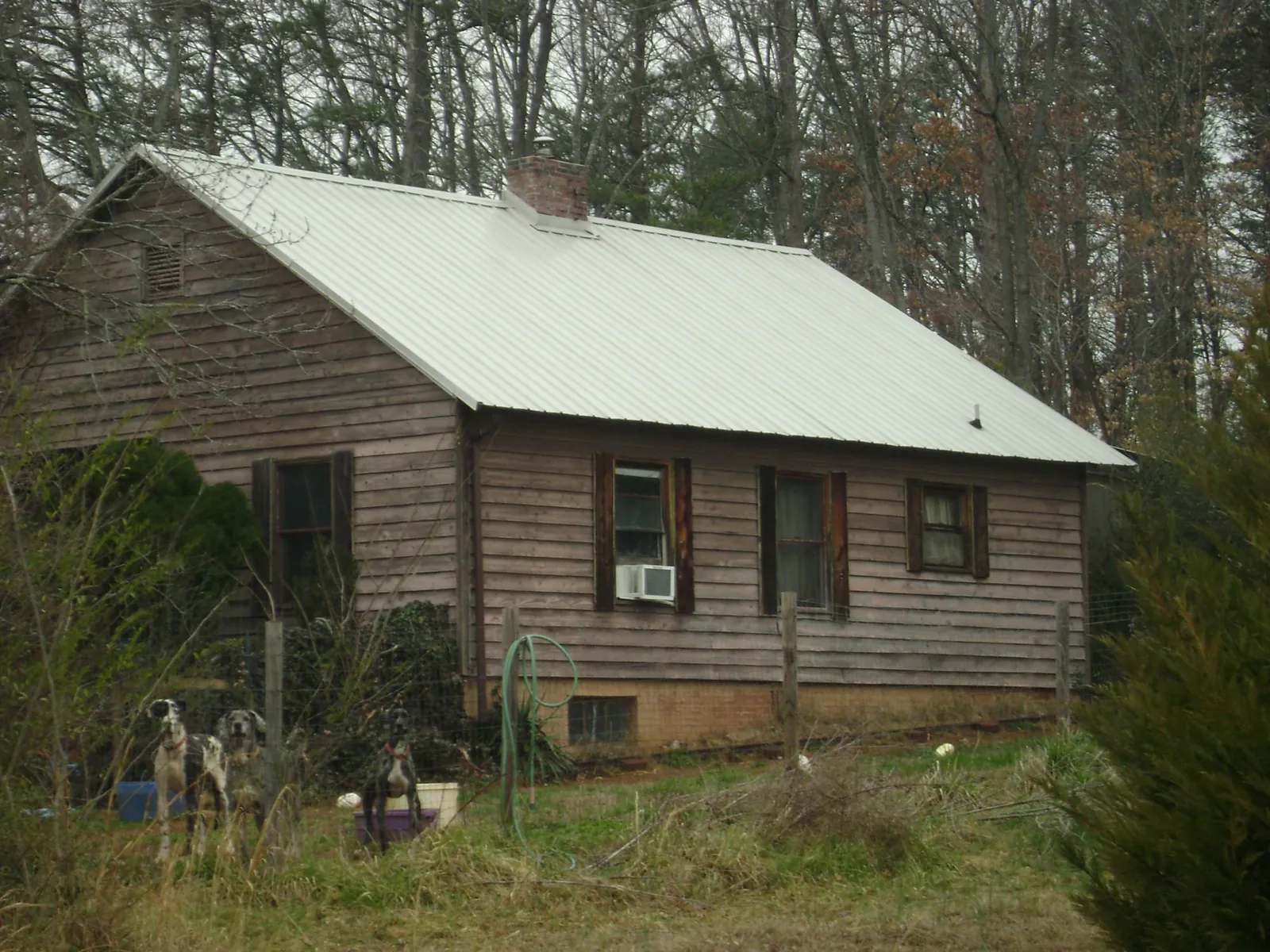 White metal roof on an old wood sided farmhouse, from a Metal Roof Installation job in Bolivia
